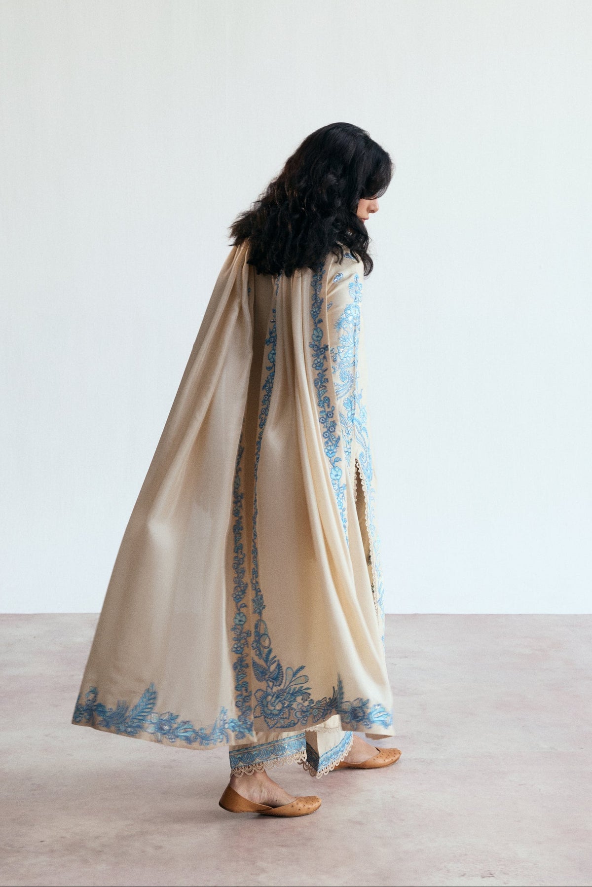 Full-length view of the Opalite Set featuring a long cream shirt and wide-leg raw silk trousers.