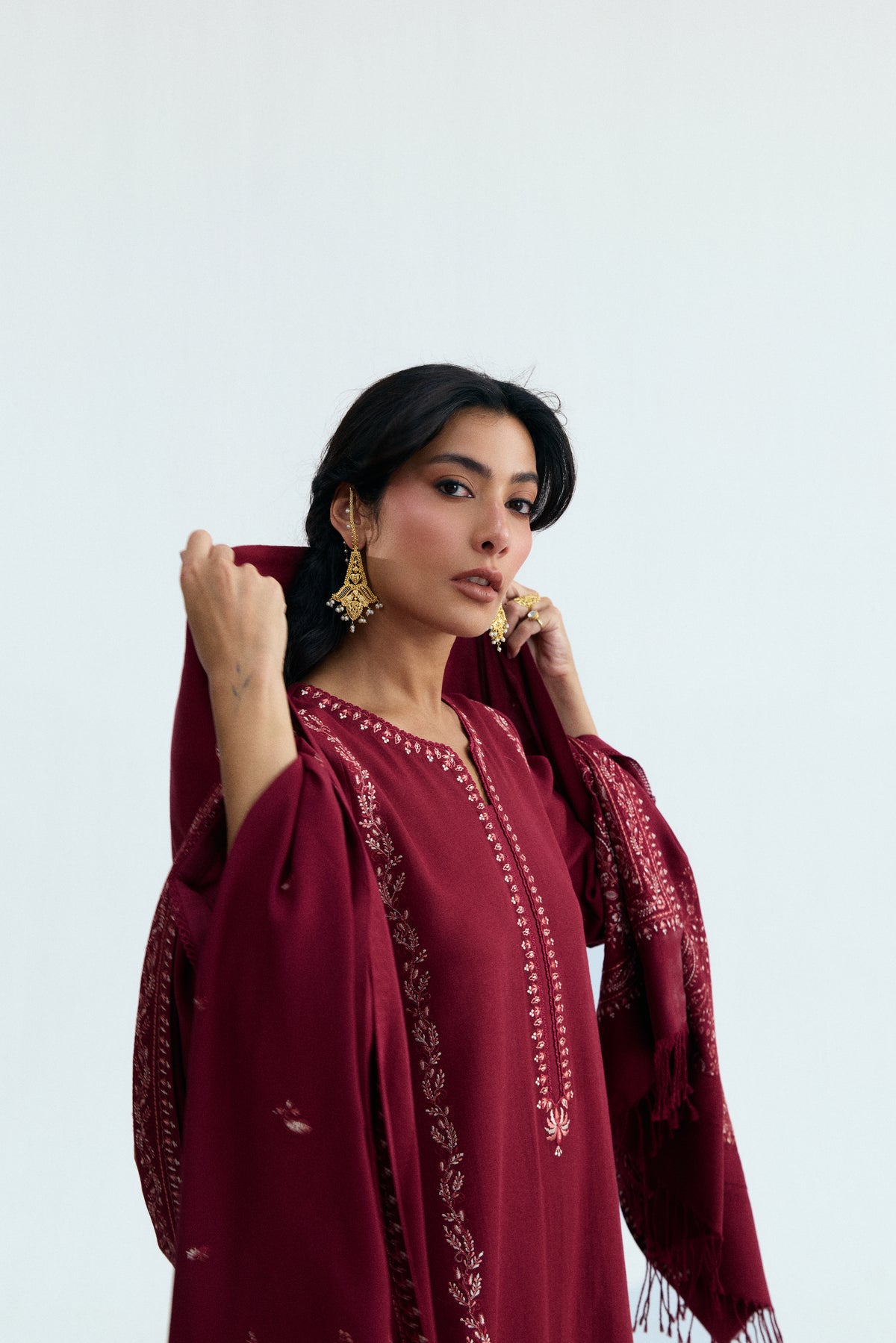 Side view of deep red khaddar Pakistani kameez with Kashmiri embroidery and lace neckline — South Asian winter wear UK