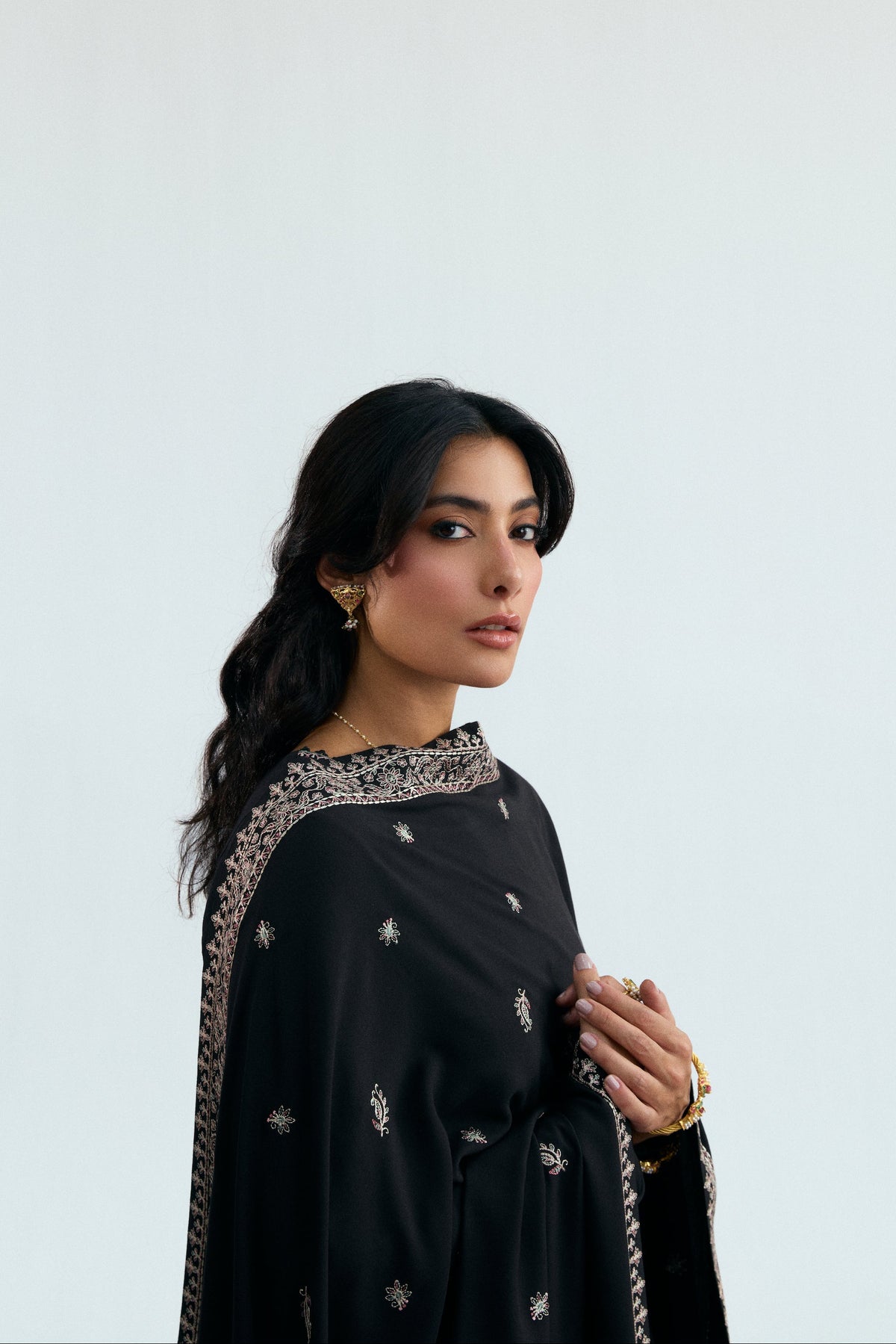 Black khaddar Pakistani winter ensemble for women — embroidered kameez, straight trousers and detailed shawl by Mannam