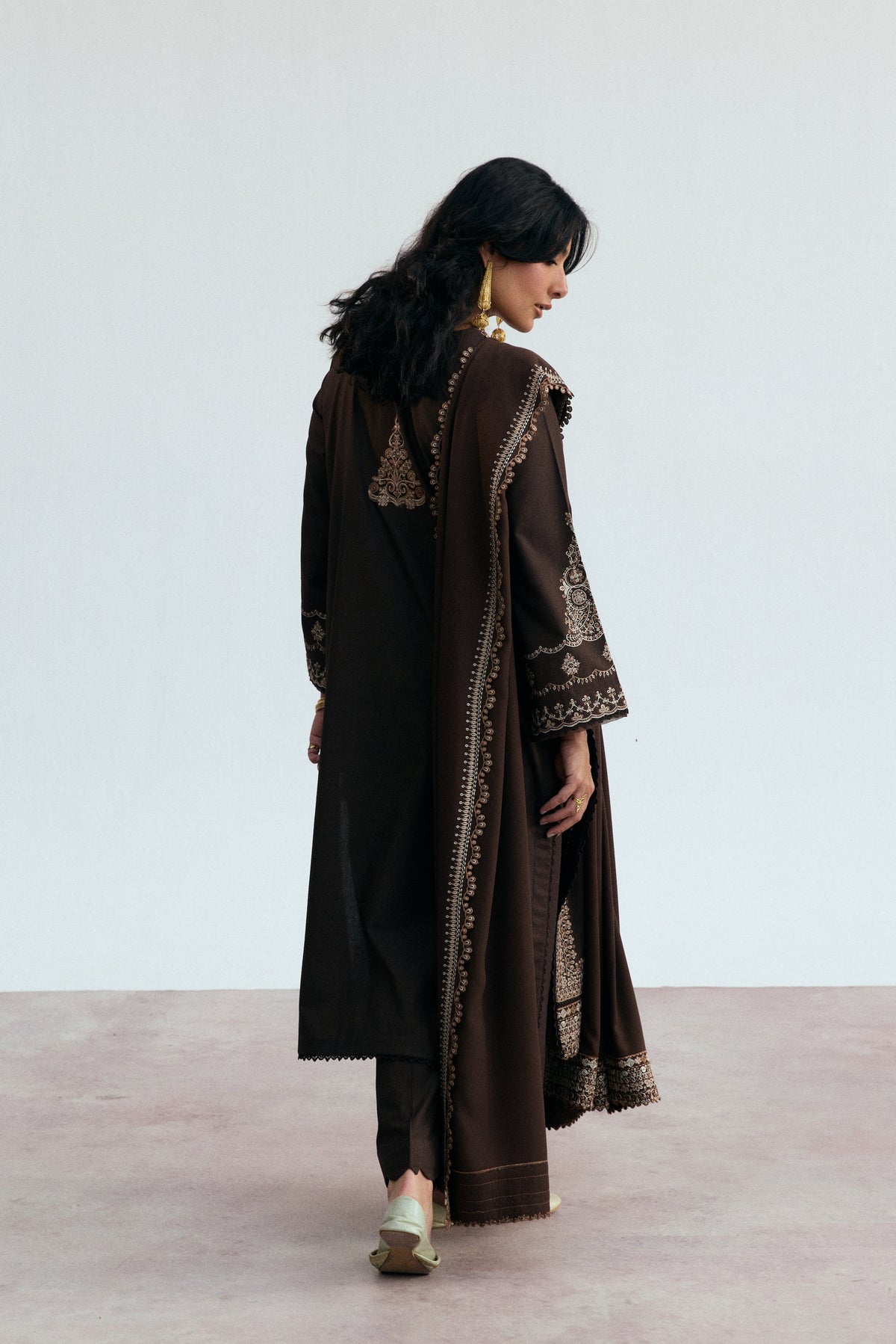 Straight khaddar trousers from the Cocoa Set by Mannam showcasing the premium cut-work edge detail on a dark brown winter salwar kameez trouser.