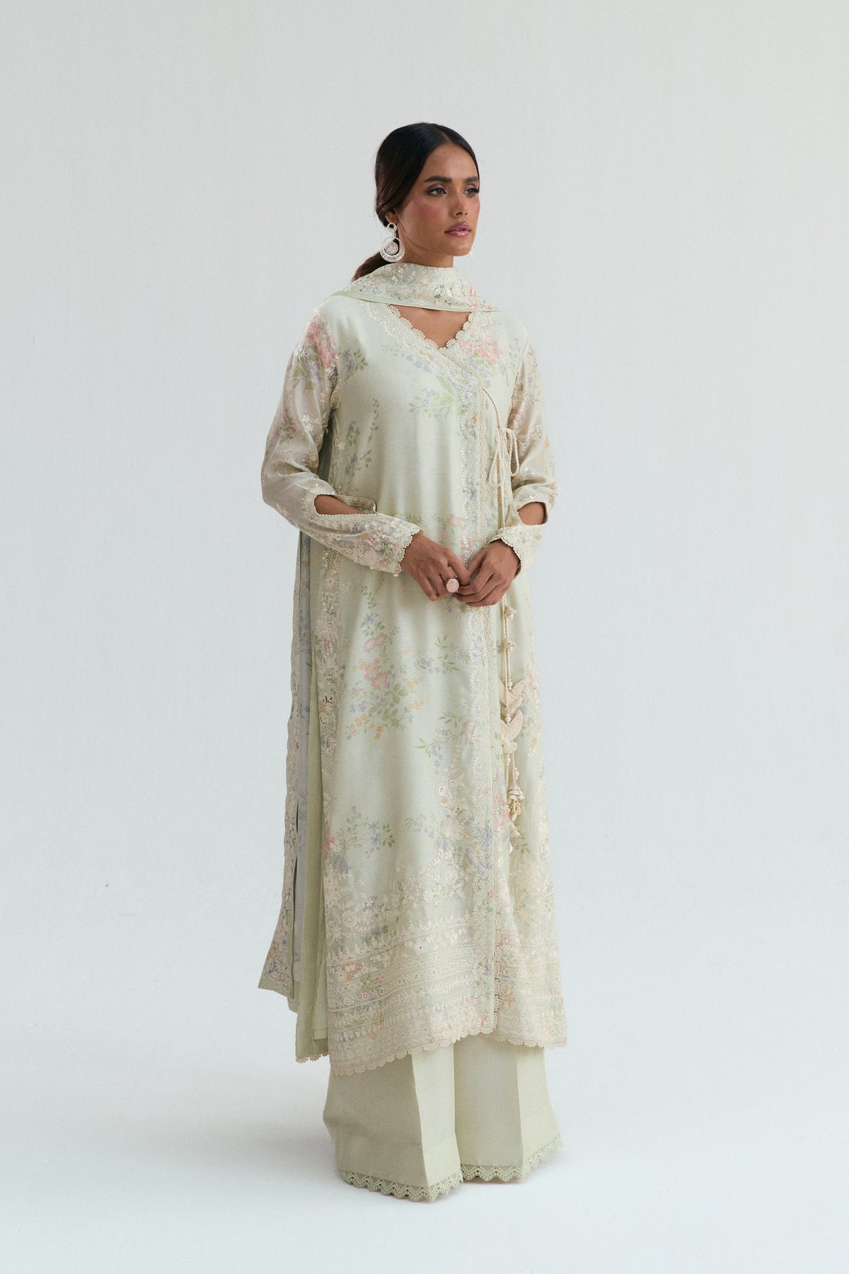 Soft green-beige pastel Pakistani salwar kameez in luxury angrakha silhouette, full front view for UK formal wear