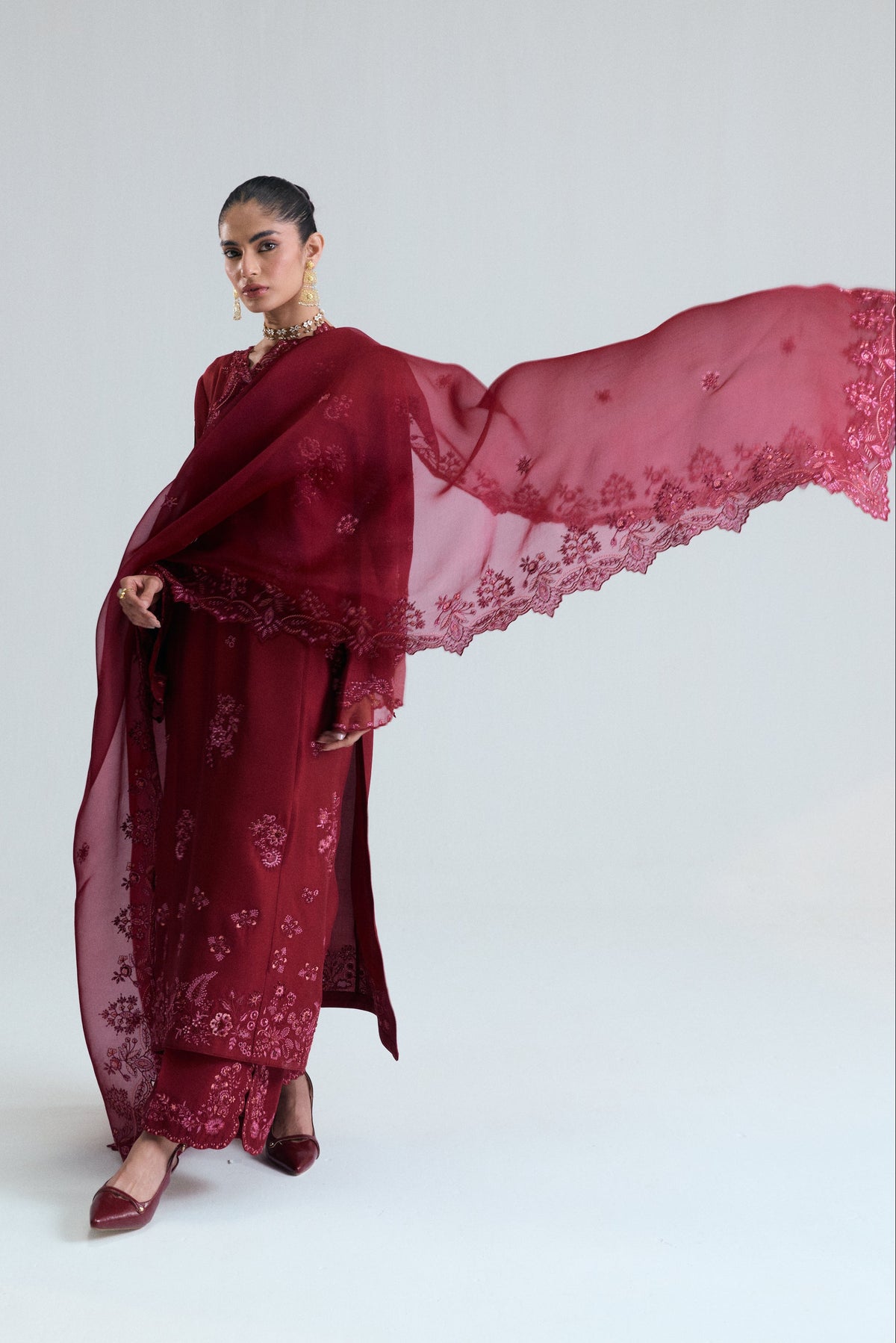 Close detail of maroon raw silk Pakistani kameez showing floral threadwork, sequins and metallic accents — Mannam Cranberry Set