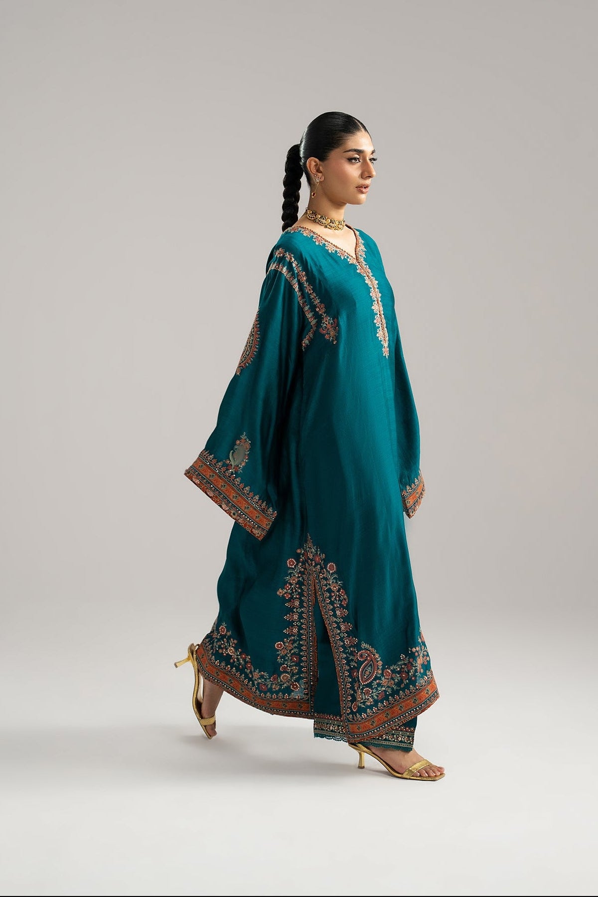 Full-length view of Mannam Afroz teal phiran set with raw silk embroidered trousers