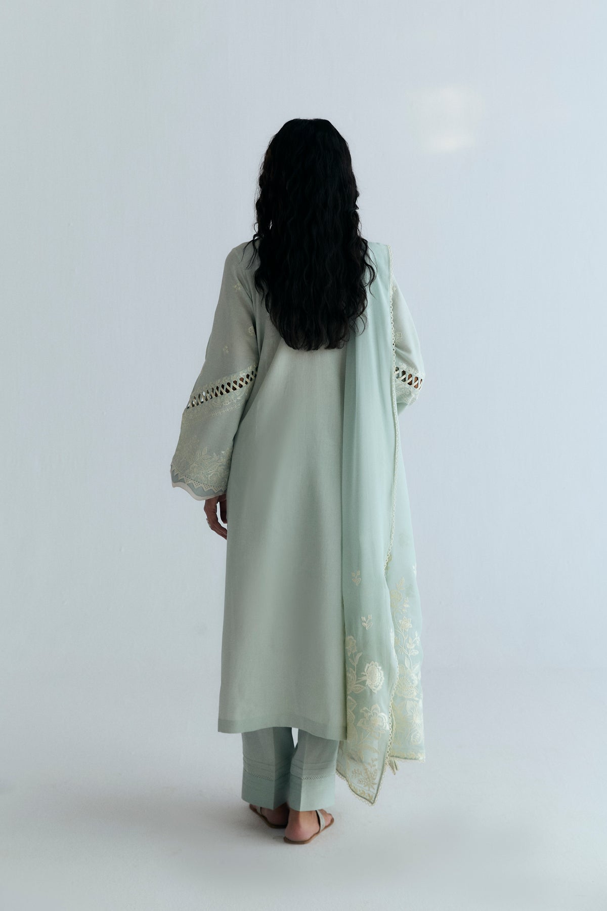 Designer powder blue Pakistani Pima cotton kameez with intricate cutwork and soft floral borders on dupatta