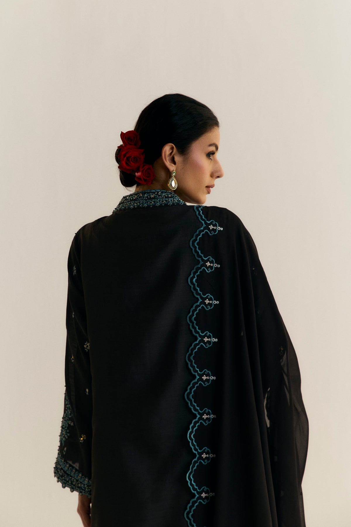 Women wearing Mannam Onyx Set — black khaadi silk jacket kameez with azure embroidery for formal Pakistani occasions