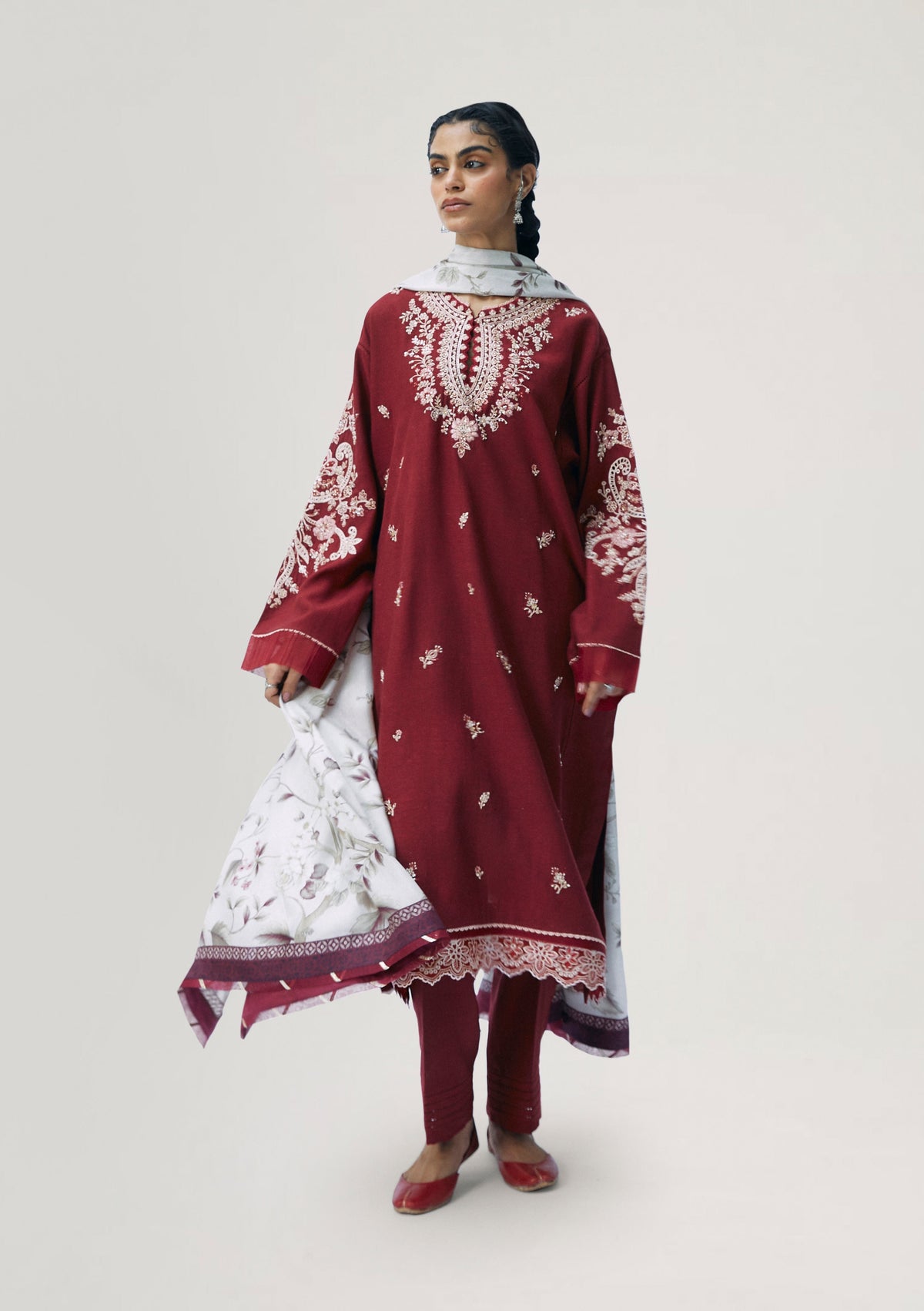 Side view of Ruby red three-panel kameez with hand-embellished sleeves and pintuck trousers — South Asian designer dress by Mannam