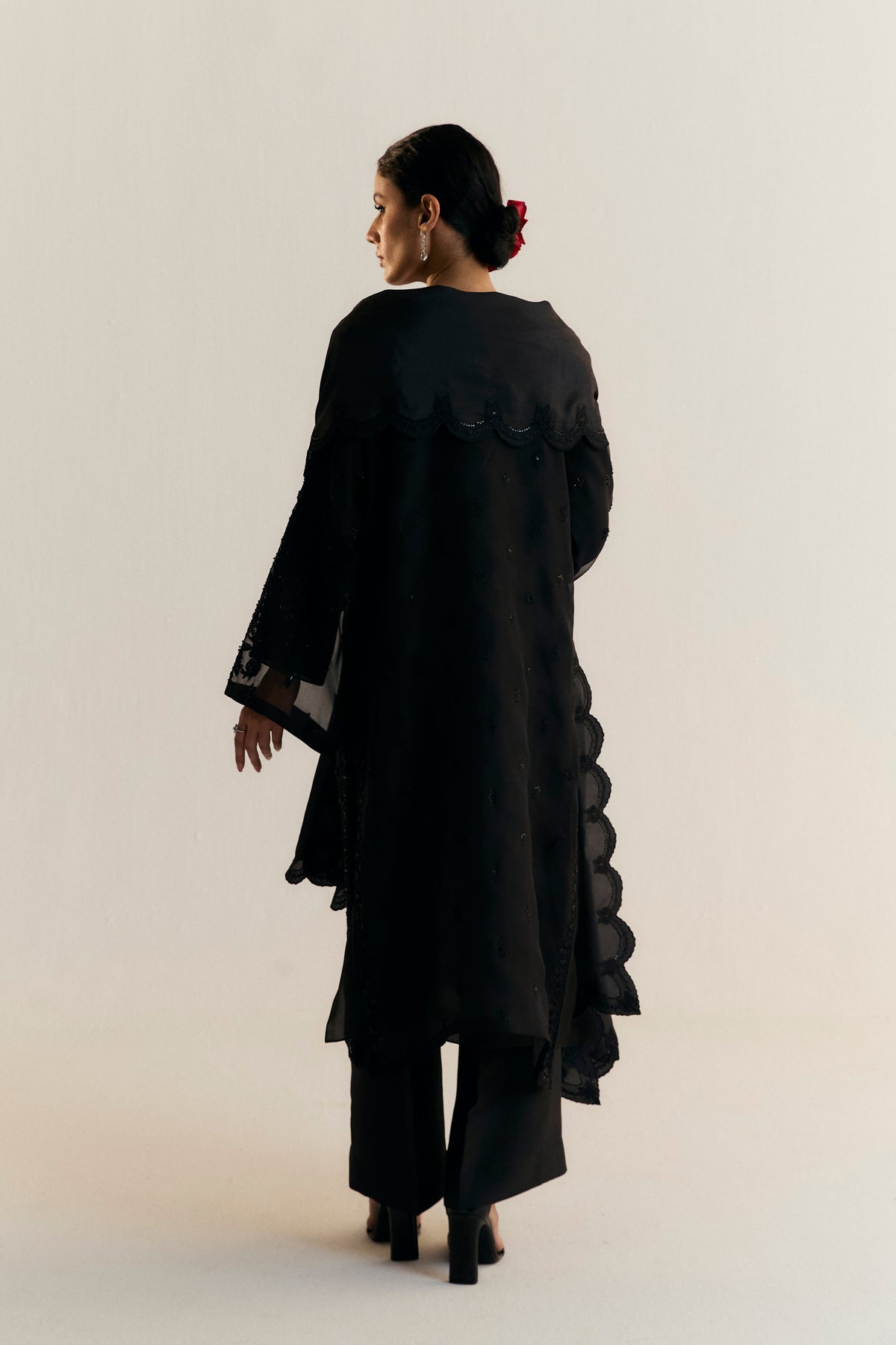 Black wedding guest outfit for South Asian women — Mannam Raven luxury organza kameez with floral embellishments and raw silk culottes