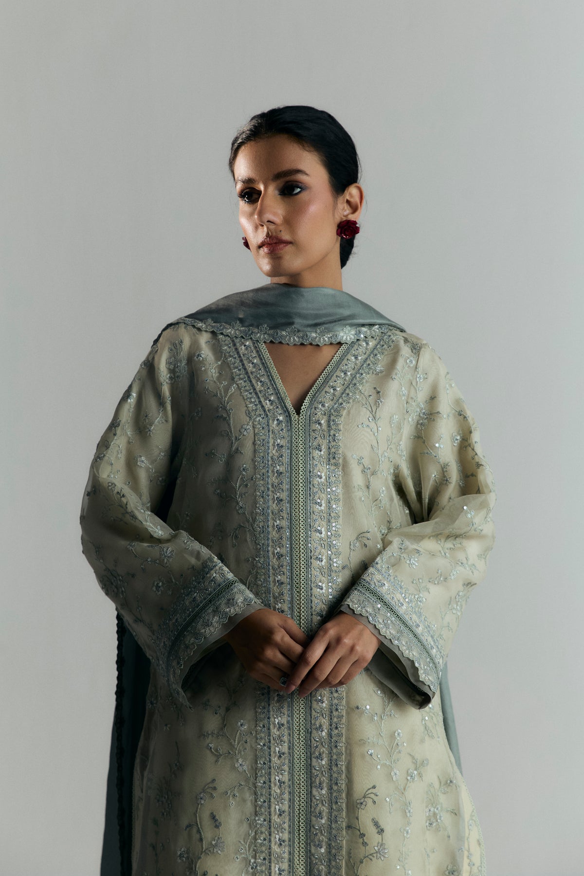Pure white organza Pakistani kameez — full embroidery and grey peeking through transparent sleeves