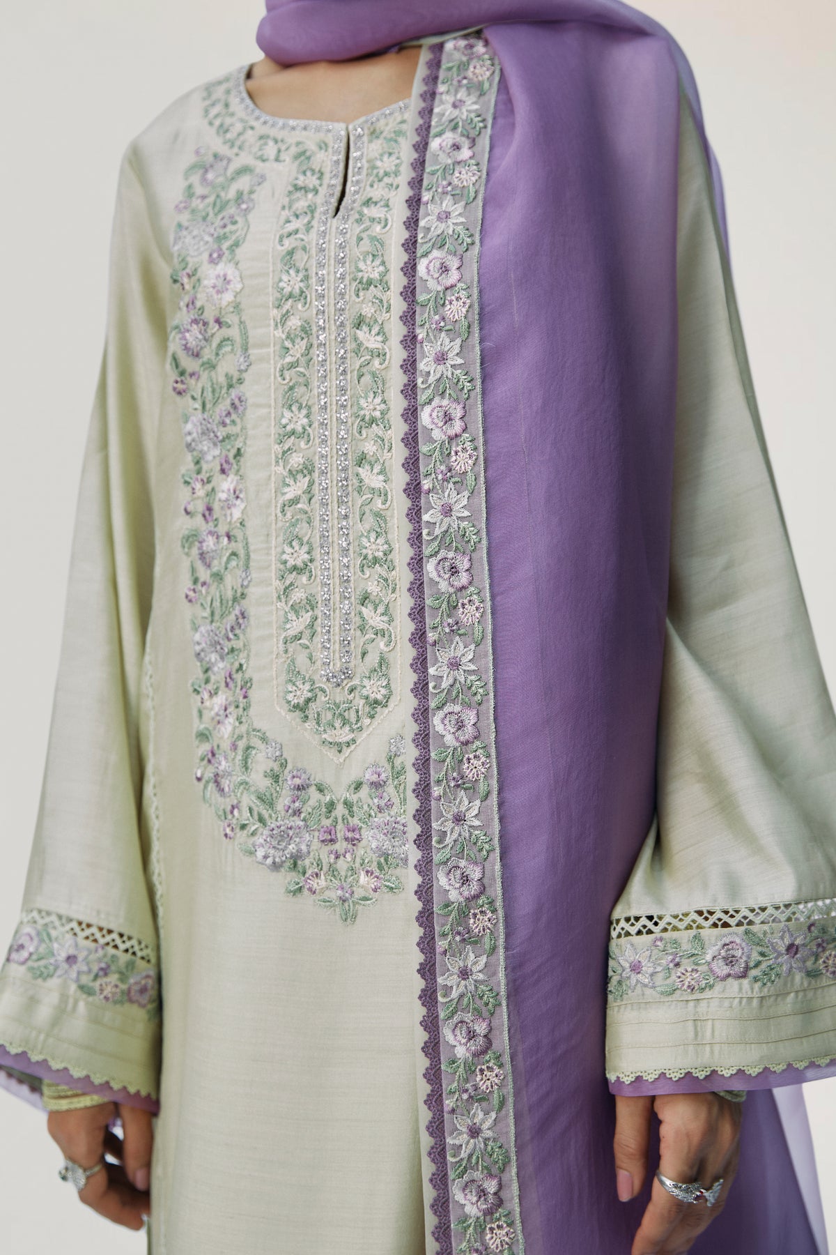 Purple border detail — lace finishings peeking through pistachio kameez