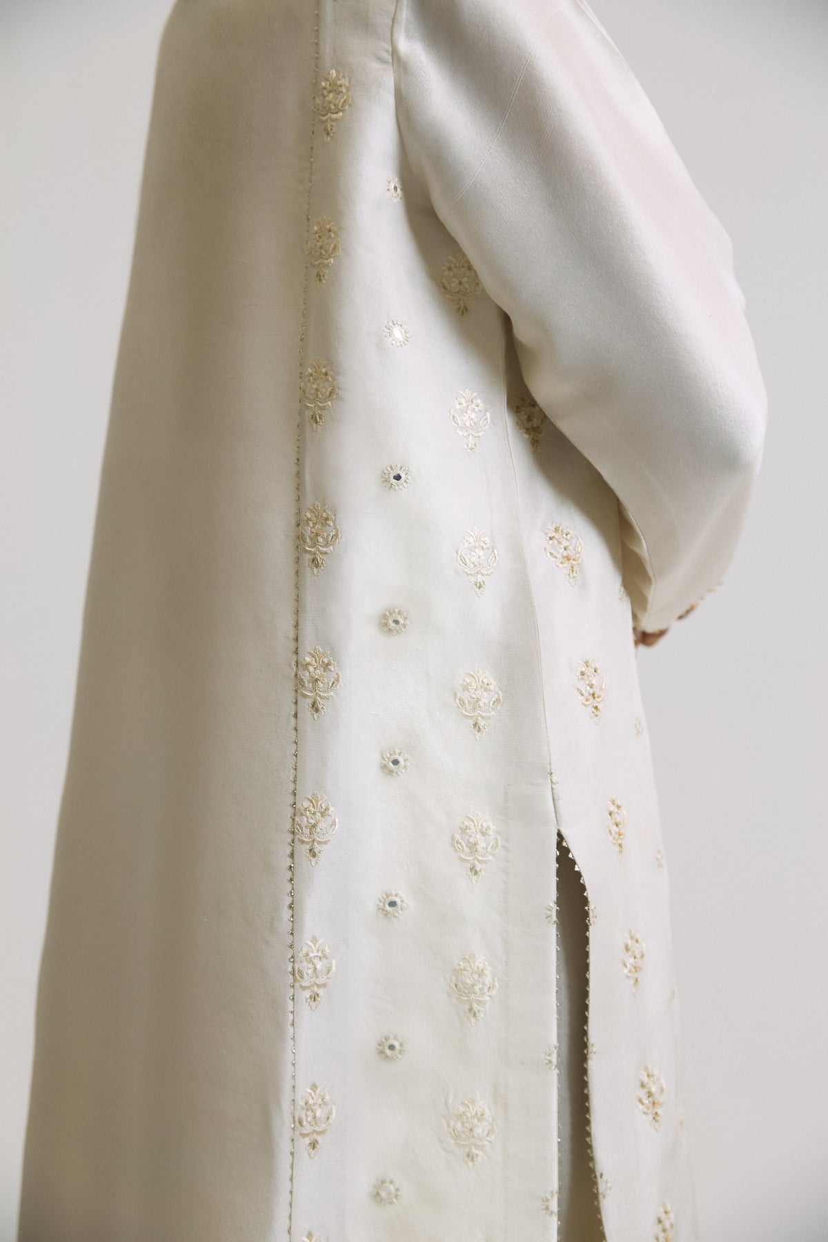 Elegant Pakistani wedding wear raw silk Pearl kameez with gota embroidery and mirror work side panel details — luxury pret by Mannam