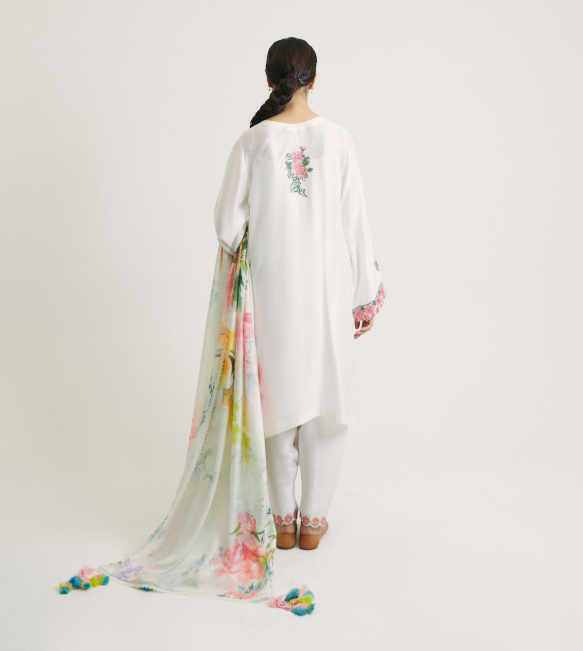 Designer white Pakistani shalwar kameez outfit with floral embroidery throughout and embroidered back motif — festive ethnic wear