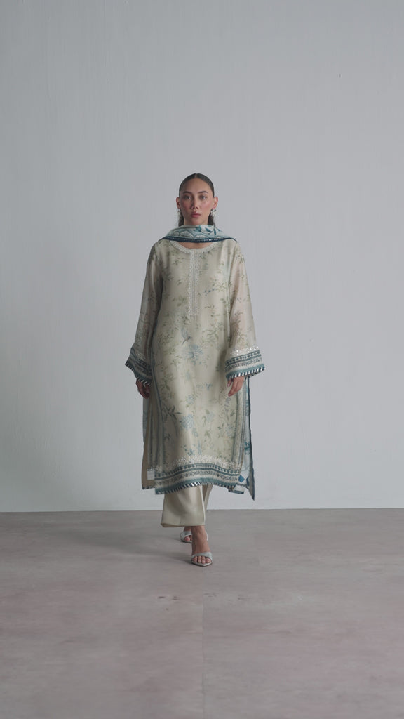 The Wishbone Set by Mannam is a pure silk printed kameez with hand embroidery on the neckline, hem and sleeves, paired with a rayon slip, pure silk straight-cut trousers, and a pure silk printed dupatta with a gota embroidery border. A Pakistani luxury pret piece available in the UK.