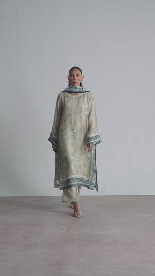 The Wishbone Set by Mannam is a pure silk printed kameez with hand embroidery on the neckline, hem and sleeves, paired with a rayon slip, pure silk straight-cut trousers, and a pure silk printed dupatta with a gota embroidery border. A Pakistani luxury pret piece available in the UK.