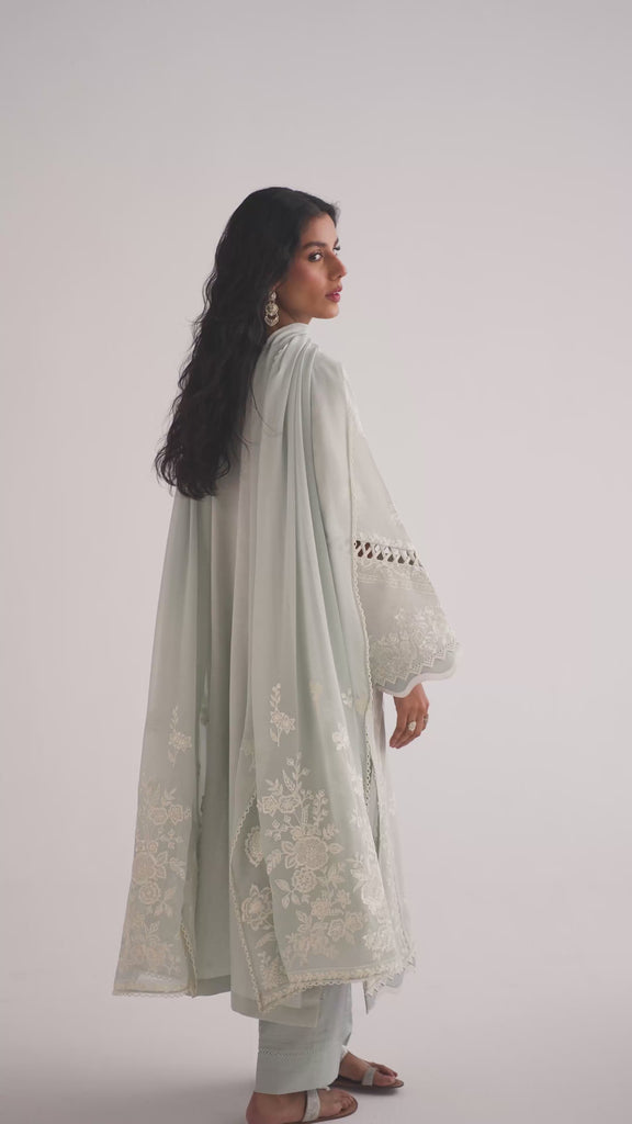 The Powder Blue Set is a powder blue Pakistani Pima cotton kameez with a cutwork neckline, wide sleeves with fabric manipulation, and tapered pleated trousers