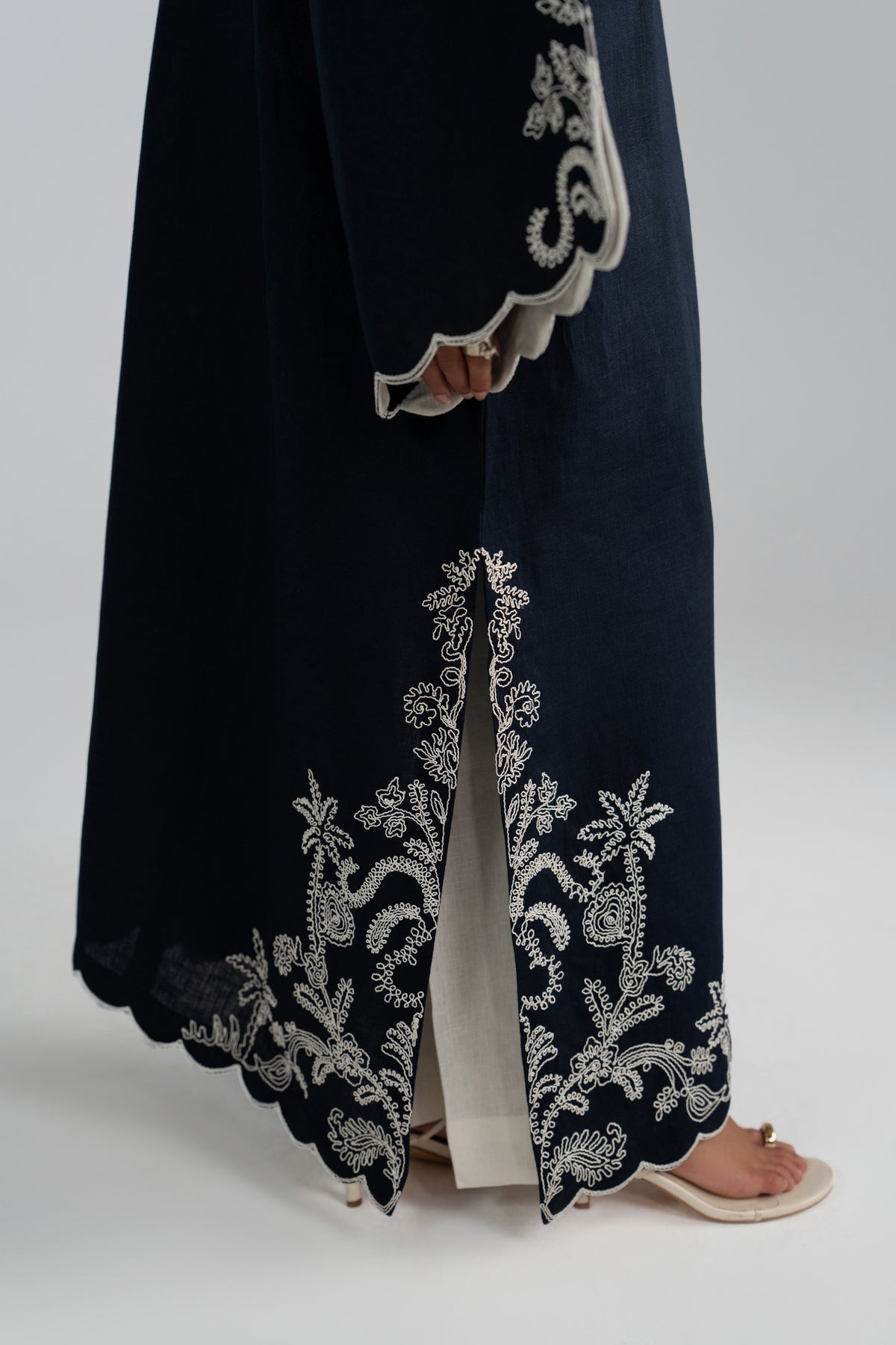 Scalloped hem slit detail on Selene Set kaftan, white trouser visible
